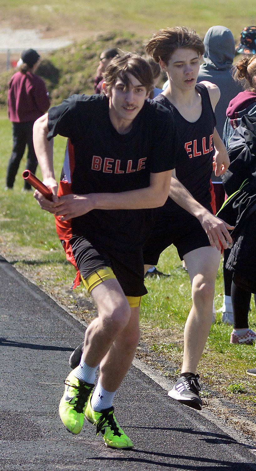 Keith Rose (far left) secures the baton from Belle Tiger teammate Cameron Niehaus during the boys 4x800-meter relay. Belle competed last night (Tuesday) in a meet at Fatima High School while Vienna is scheduled to return to action tomorrow (Thursday) at Eugene.